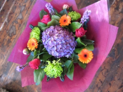 Vibrant Delight - A vibrant mixture of flowers including lime blooms, Germini, Roses and Liatris, perfect for cheering someone up.